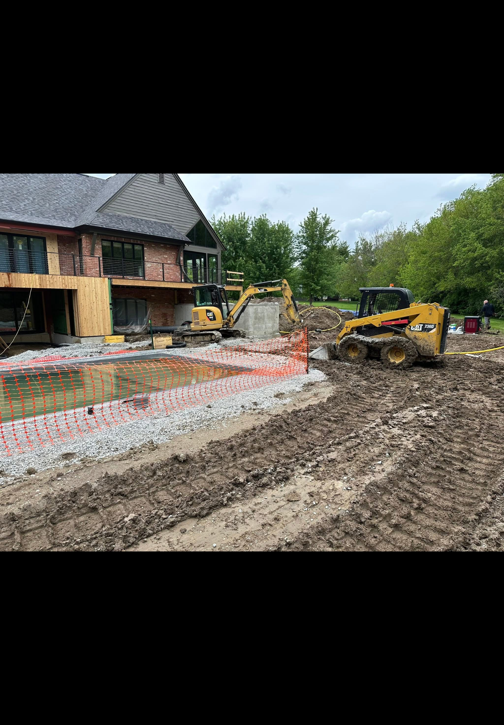 Before and after excavation and drainage work at brick home construction